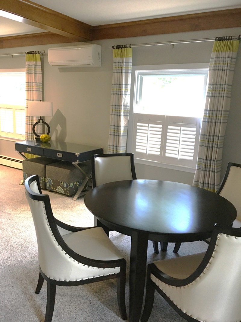 Navy blue writing table and round table with chairs.