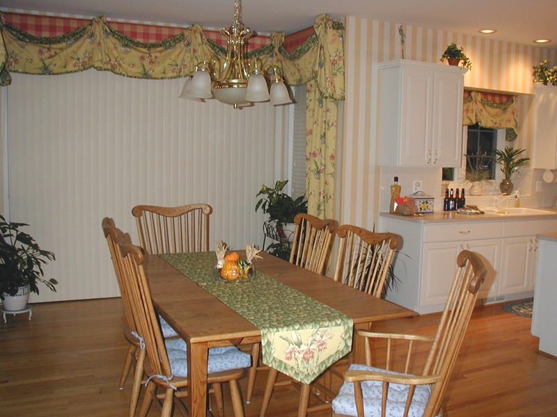 Layered valance over cornice, framed in floor length panels.