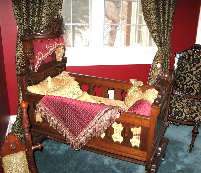 Vintage crib with beautiful bedding and pillows.