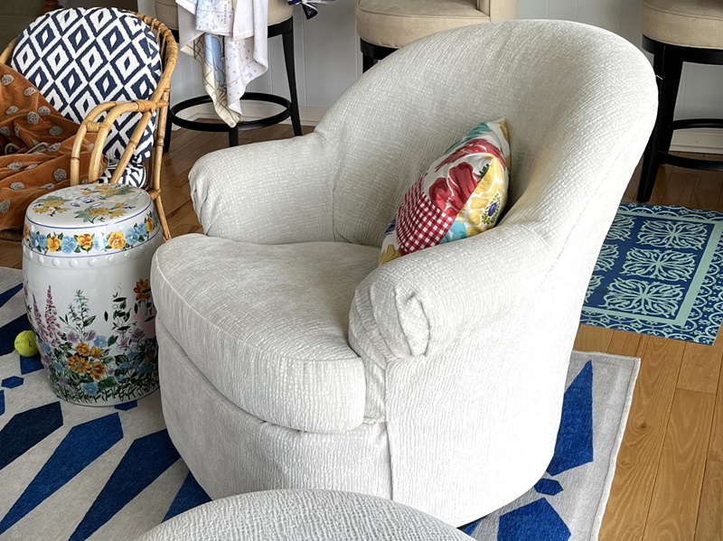 Slipcover in white chenille for swivel chair and ottoman.