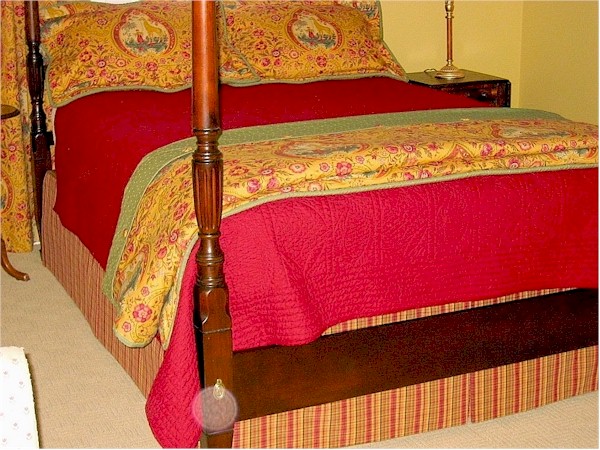 Drenched in rich reds and golds. Bedskirt, duvet, pillows.