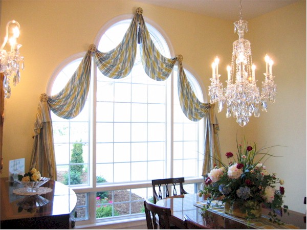 Stately swags framing dining window.